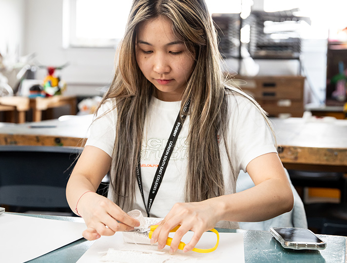 Student creating art work book